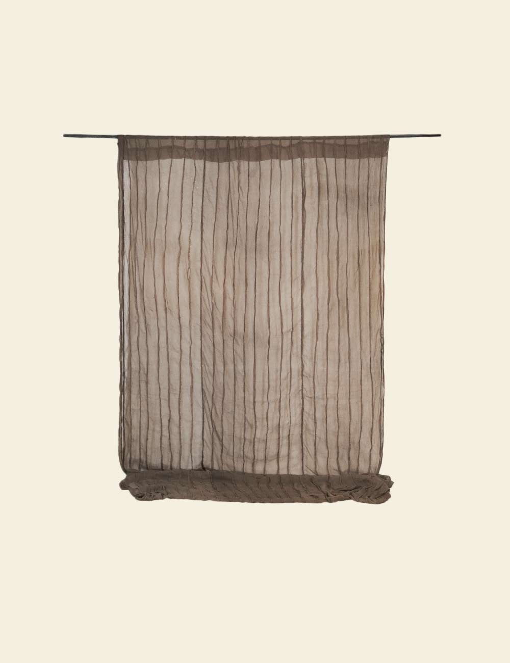Textured brown curtain on a beige background