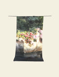 Tapestry with a scenic design of flowers and steps on a white background