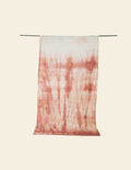 Tie-dye towel with red and white pattern on a beige background