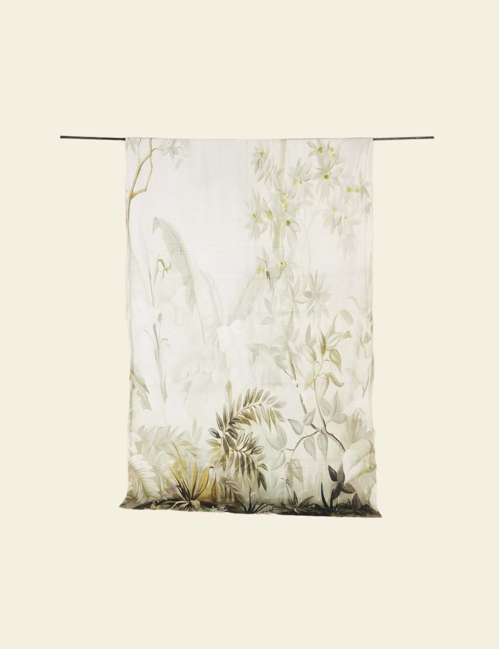 Floral patterned fabric hanging on a rod against a white background