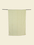 Green and white striped towel hanging on a rod against a beige background