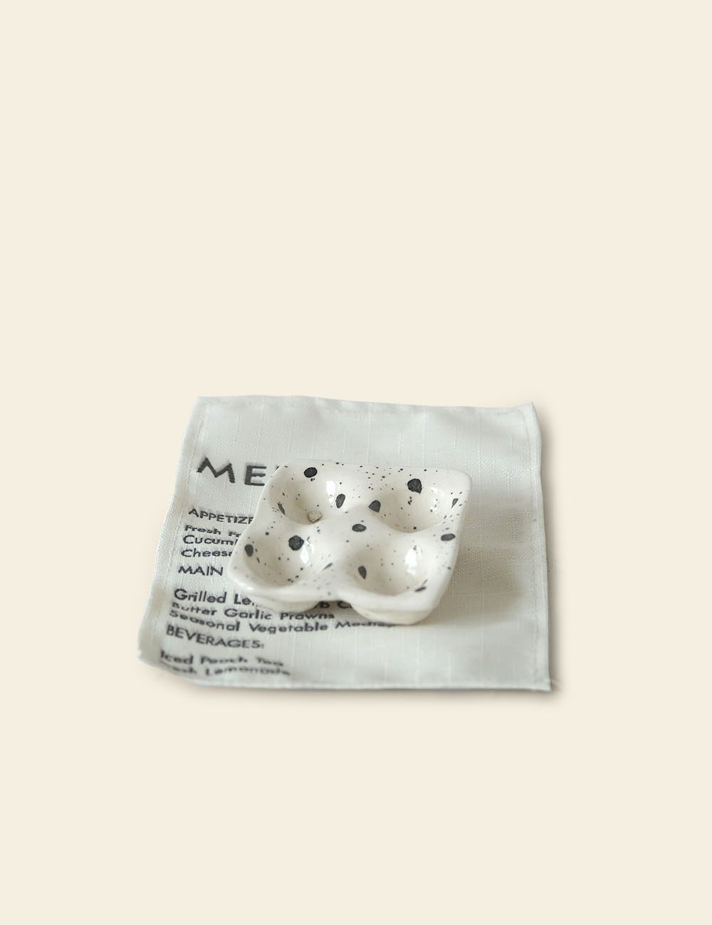 Off-White Splattered Ceramic 4-Egg Tray and Menu