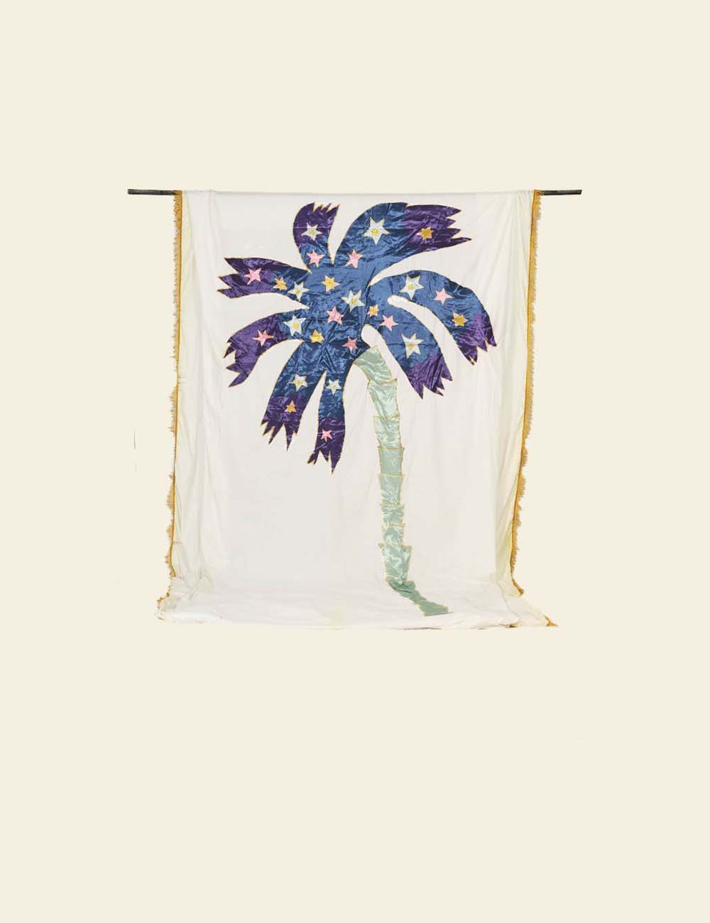 Decorative pillow with a palm tree design on a white background