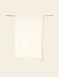 White tank top with pink trim on a beige background